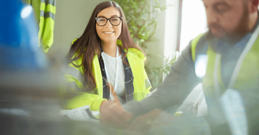 a person in safety vests talking to another person