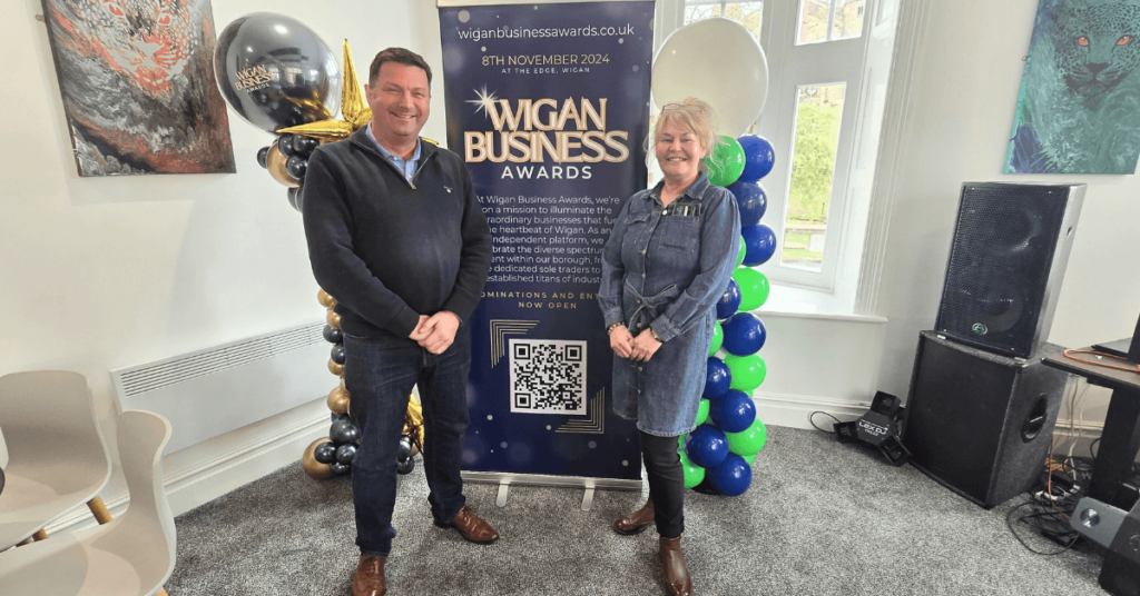 James Carman from 365 People Support and Nichola Howard from Wigan Business Awards stood beside an awards banner