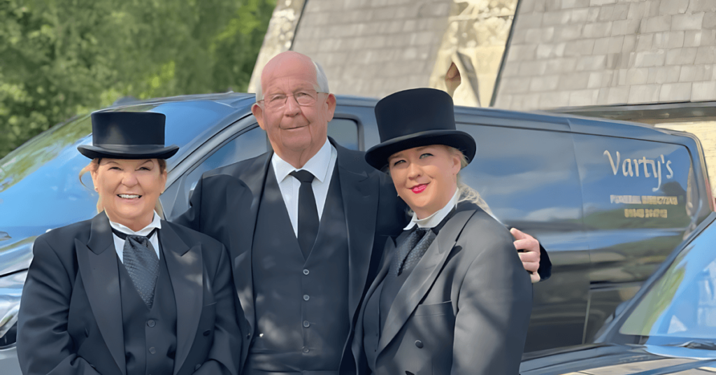 Image shows – Kim Varty, sister of Bill Varty with Bills daughter Kristen Varty in top hats standing next to a van