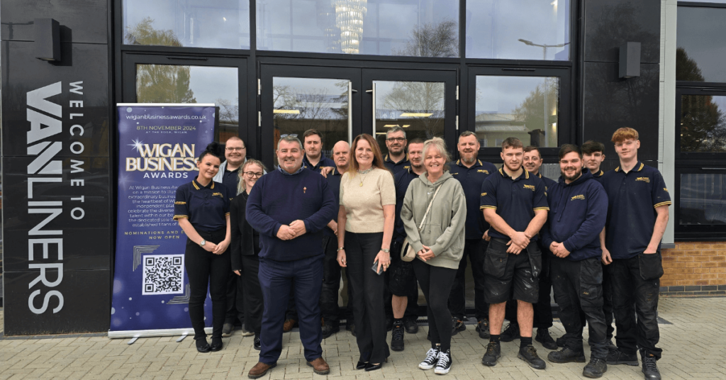 The team from Vanliners with Wigan Business Awards organiser, Jo Leigh, outside their building