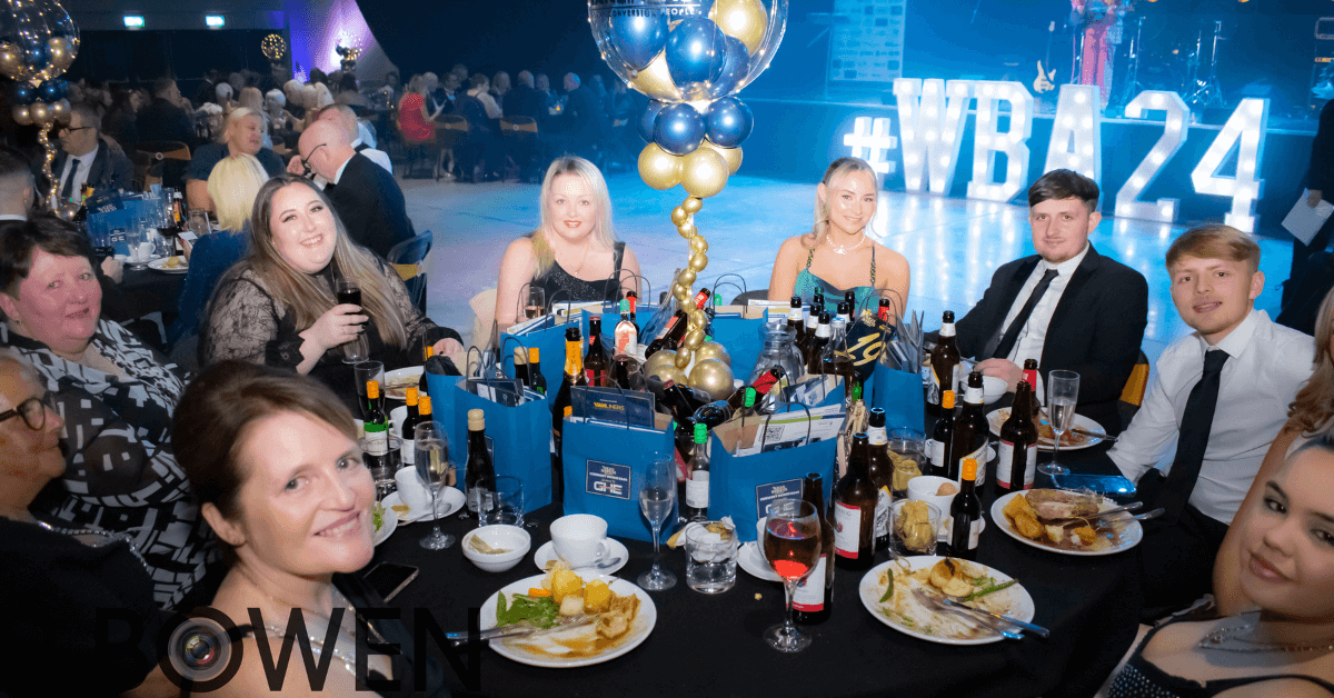 a group of people sitting around a table at an Wigan Business Awards