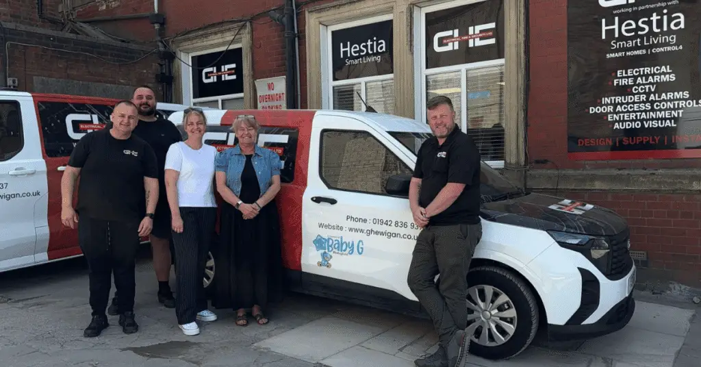 Wigan Business Awards Organisers Nichola Howard and Jo Leigh with Graham Hurst Stuart Howard and Mike Snape from GHE fire and security with a GHE branded van
