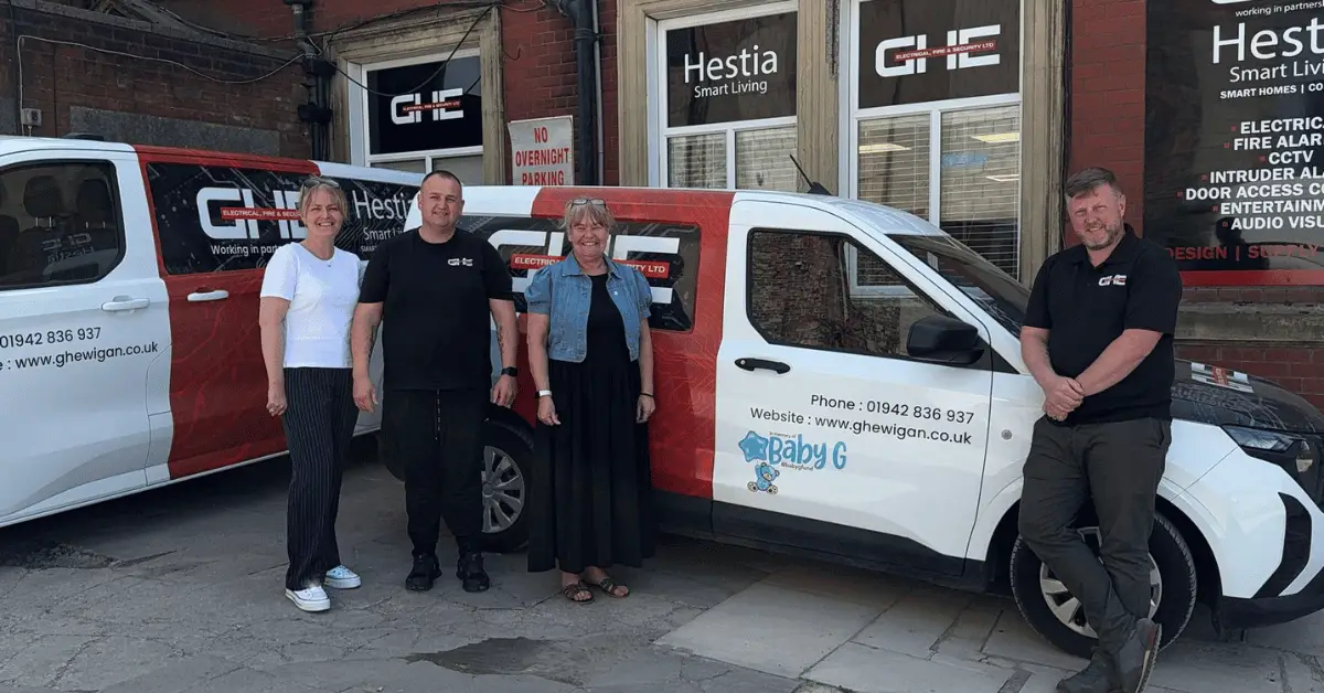 GHE fire and electrical company directors Graham Hurst and Stuart Howard with Wigan Business Awards Organisers Jo Leigh and Nichola Howard stood in front of GHE branded van and offices