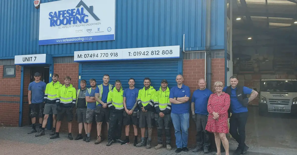 Image shows the team at Safeseal Roofing stood with Wigan Business Awards organiser Nichola Howard