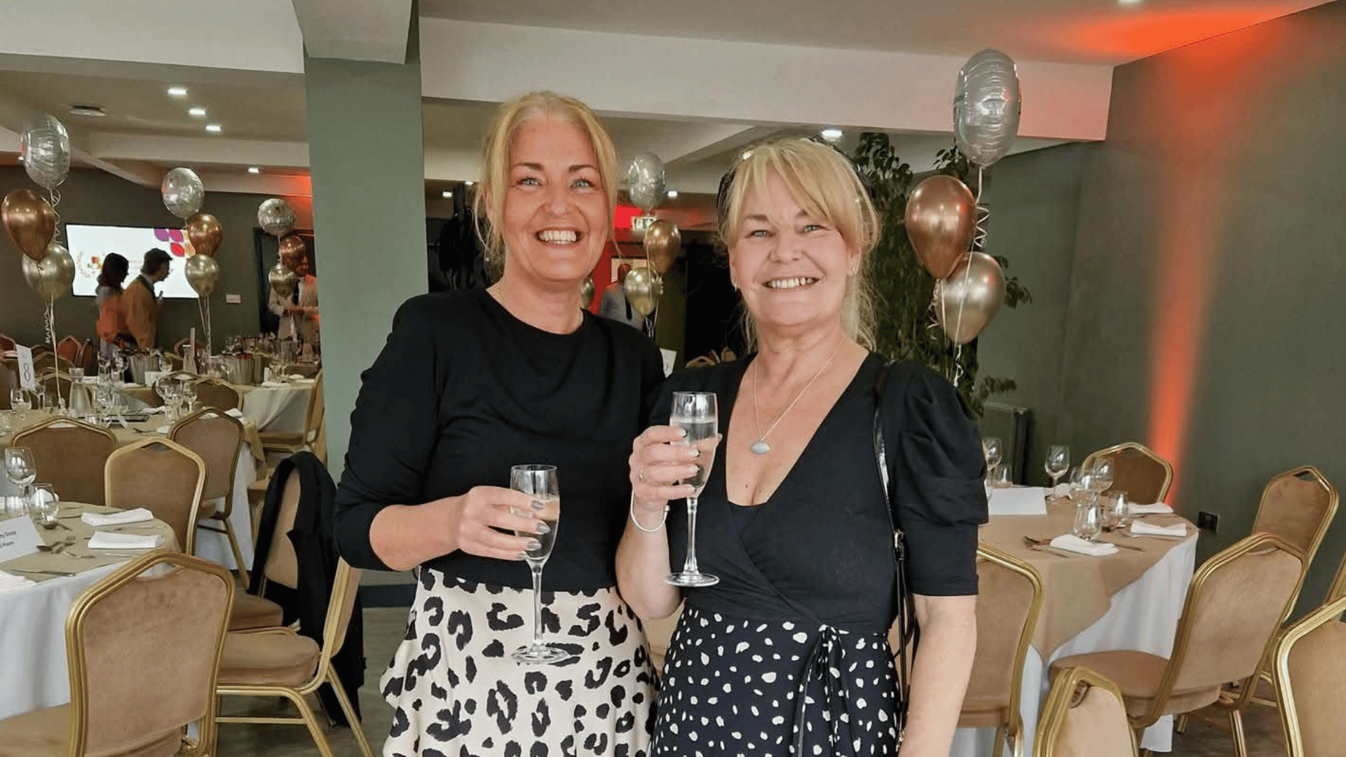 Image shows Jo Leigh and Nichola Howard from Launch NW smiling holding Champagne glasses