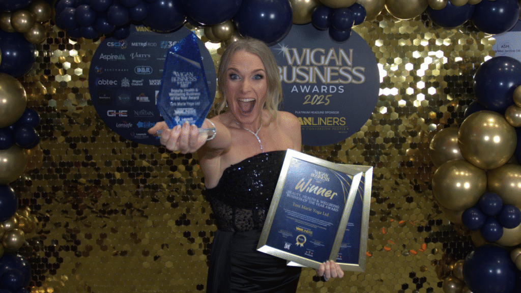 Wigan-Business-Awards-202425-Winner-Toni-Marie-Yoga-Smiling- holding her trophy out to the camera